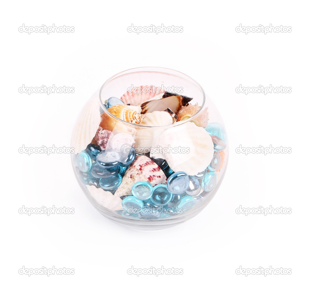 Round jar with shells and blue stones isolated on white
