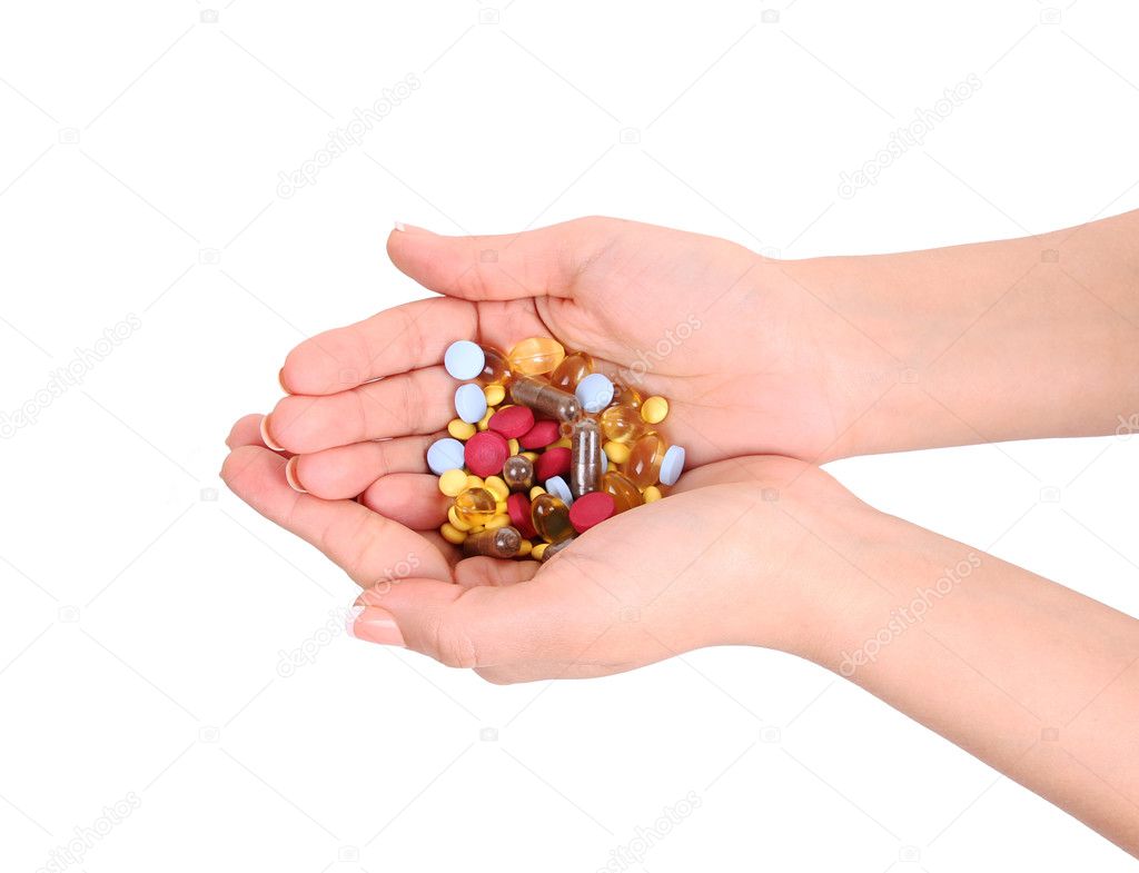 Pills in hands isolated on white