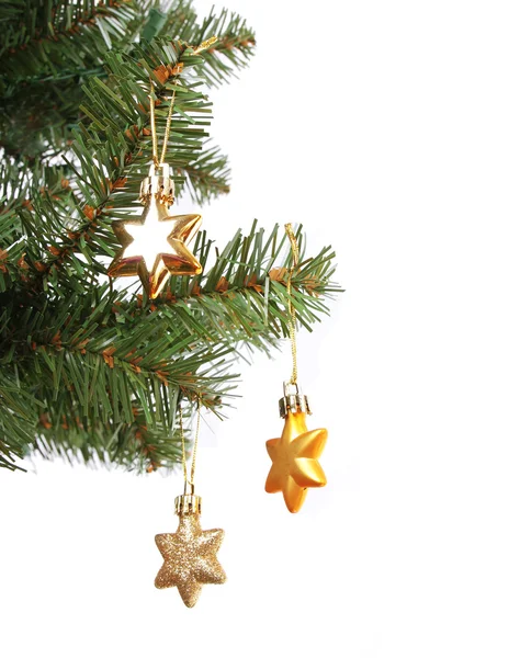 Gold stars on Christmas tree branch, isolated on white background — Stock Photo, Image