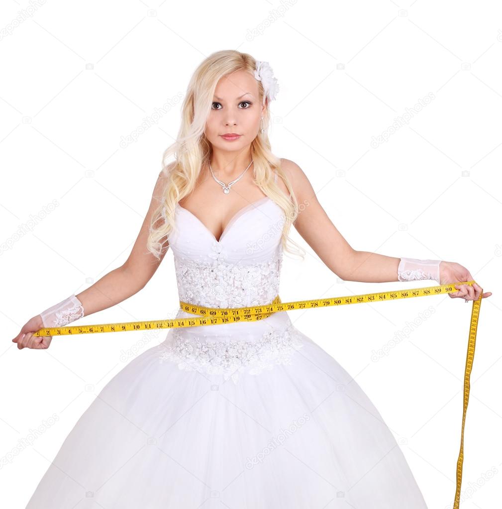 Bride measuring her wedding dress isolated on white