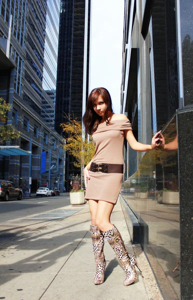 Young girl in sexy boots posing in a city — Stock Photo, Image