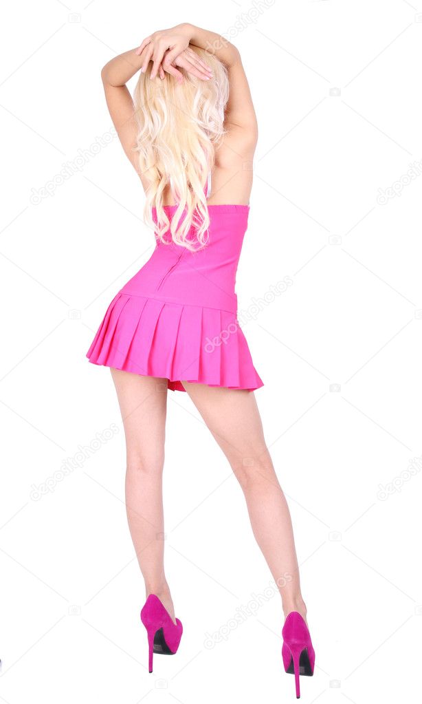 Backside of dancing blonde woman in short pink dress and high heels on her sexy legs isolated on white