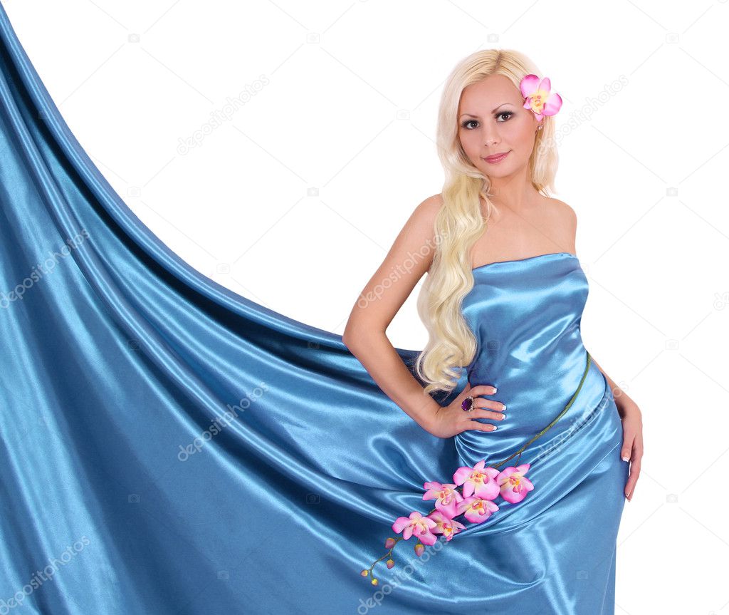 Beautiful blonde young woman in turquoise silk dress with orchid flowers isolated on white