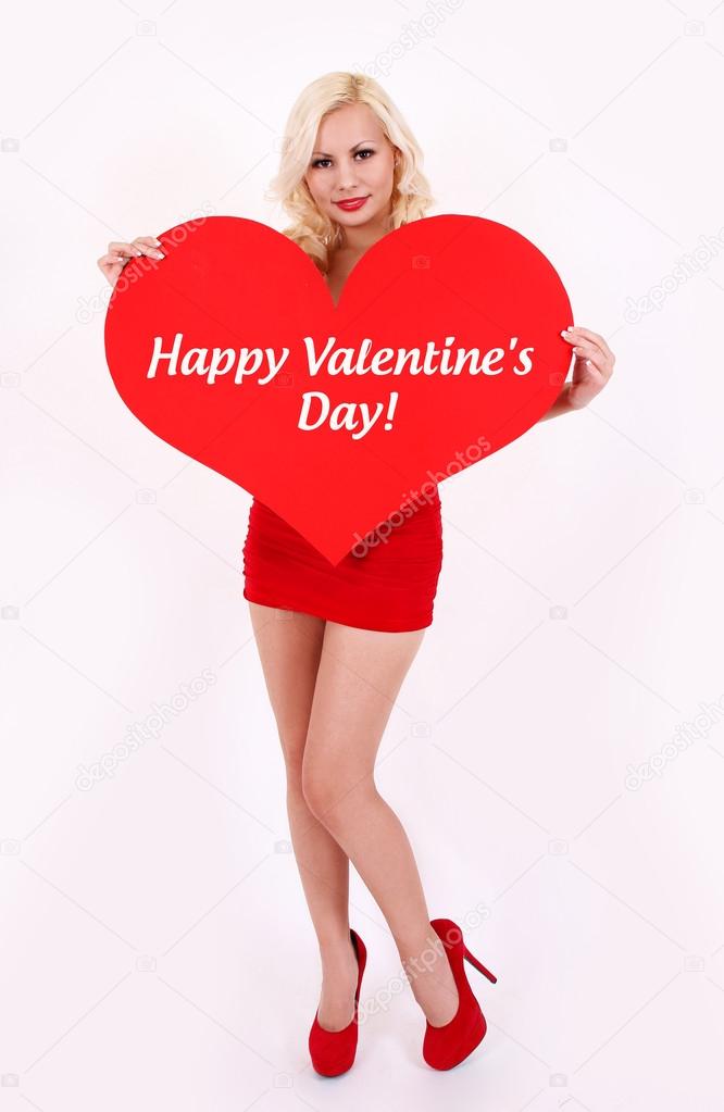 Sexy blonde young woman holding red heart with words Happy Valentines' day on white
