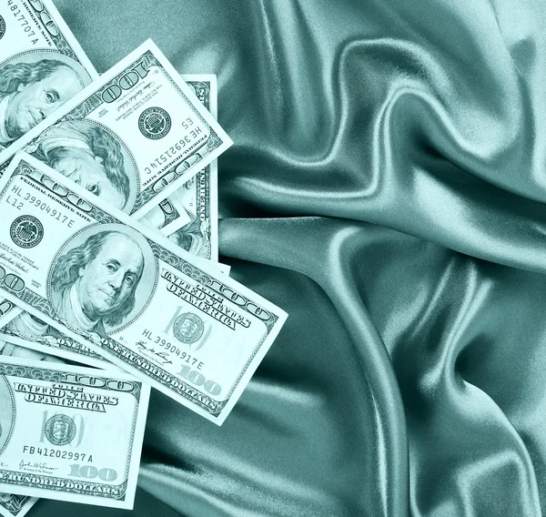 Dollars bills on green silk fabric, sexy money — Stock Photo, Image