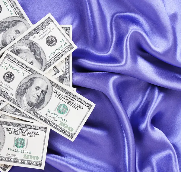 Dollars bills on blue silk fabric, sexy money — Stock Photo, Image