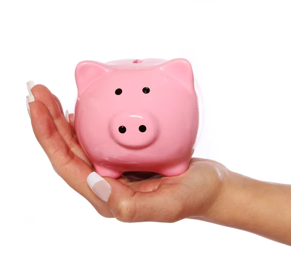 Piggy bank in vrouwelijke hand geïsoleerd op witte achtergrond — Stockfoto