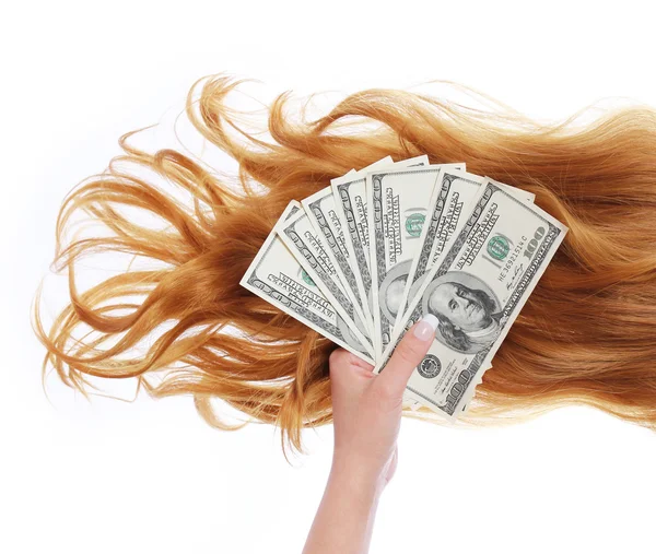 Geld en krullend bruin haar over witte achtergrond, dollar facturen in vrouwelijke hand, kapsalon — Stockfoto