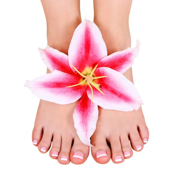 Pedicura. hermosos pies femeninos con flor de lirio aislado en blanco, spa — Foto de Stock