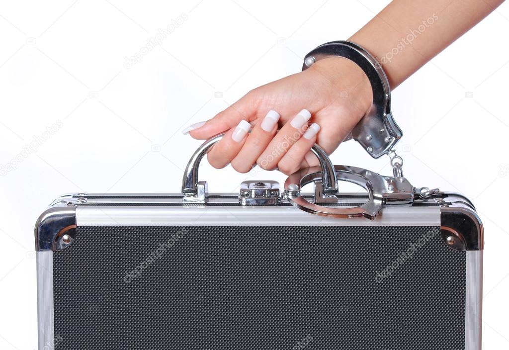 Case of money in handcuffs with female hand, isolated on white. concert