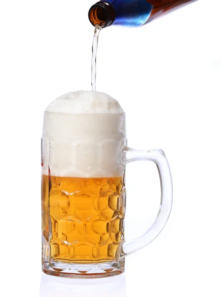 Beer pouring into mug isolated on white backgroun — Stock Photo, Image