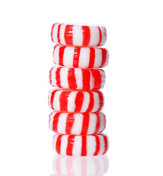 Peppermint candy tower isolated on white. Red striped peppermint Christmas candy, macro. — Stock Photo, Image