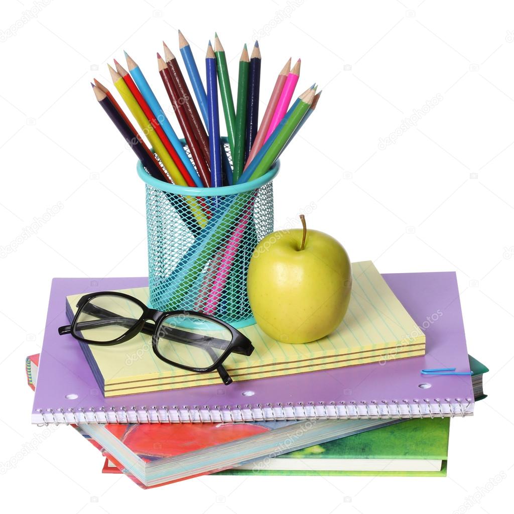 Back to school concept. An apple, colored pencils and glasses on pile of books isolated on white background