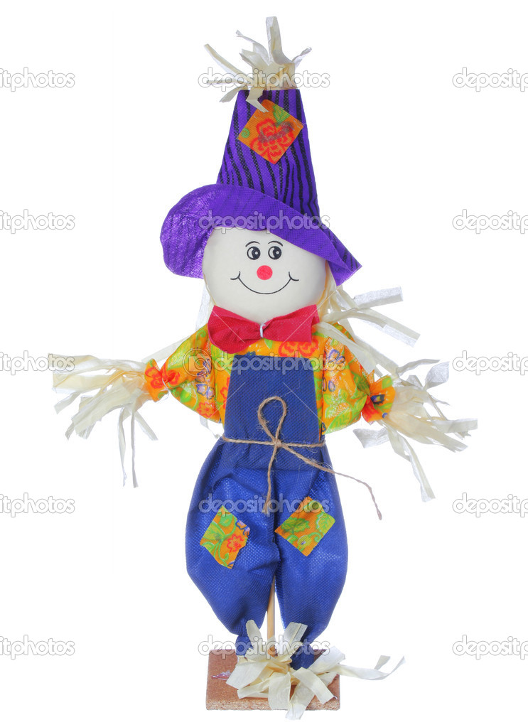 Smiling scarecrow in colorful clothes isolated on white background. Halloween image.