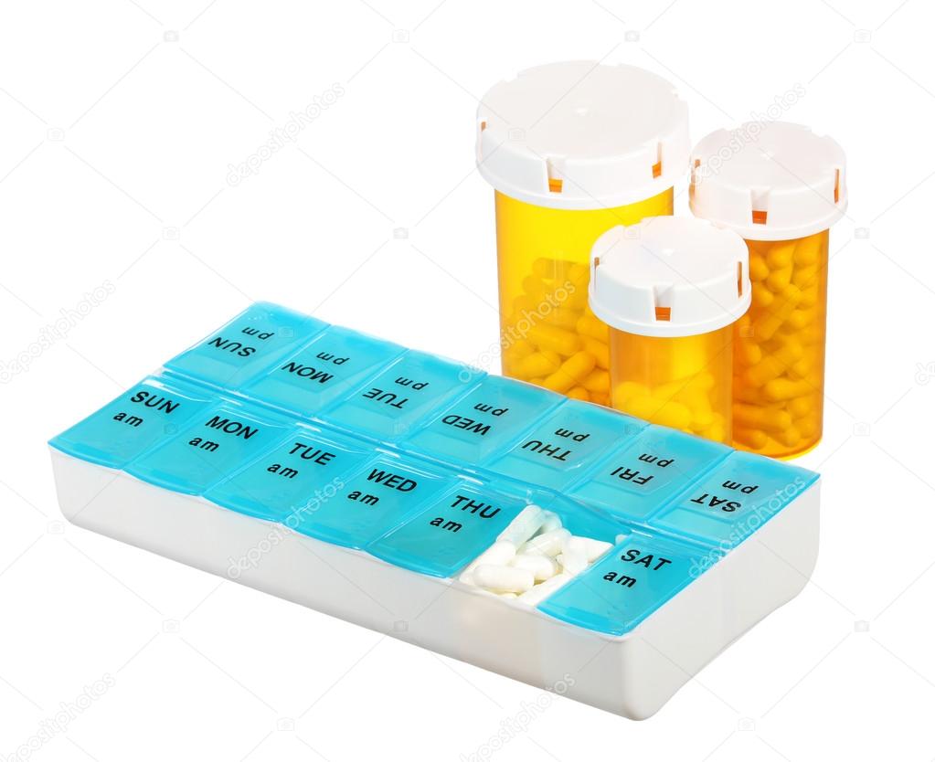 Pill bottles and medicine dose box isolated on white background. Weekly