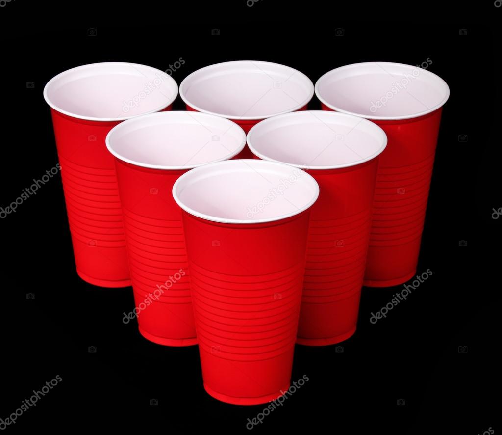 Beer pong. Red plastic cups over black background