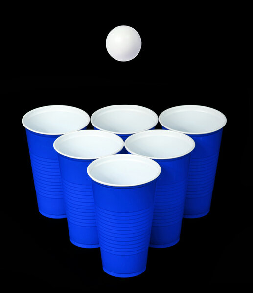 Beer pong. Blue plastic cups and ping pong ball over black background