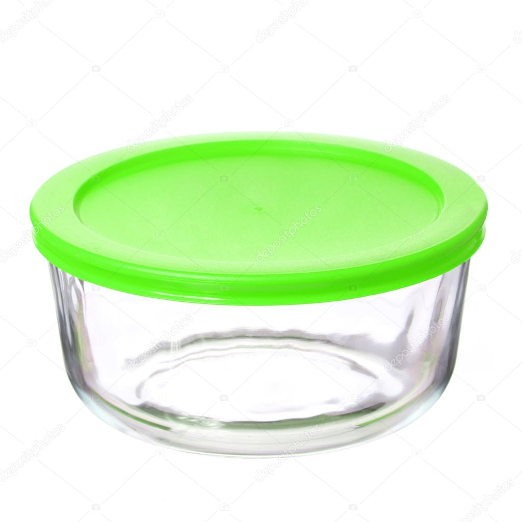 Glass food container with green plastic lid isolated on white background