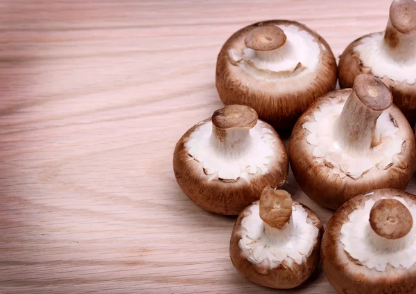 Mushrooms over wooden background. Baby Bella — Stock Photo, Image