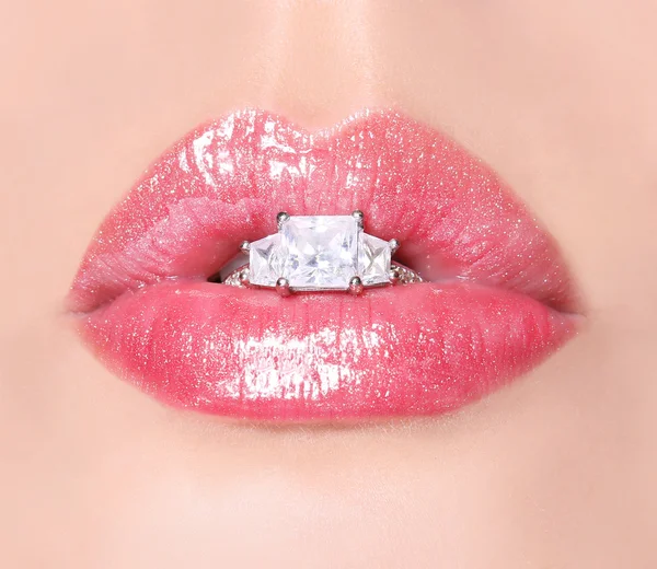 ダイヤの指輪を持つセクシーな唇。美容のピンクの唇の光沢。口 — ストック写真
