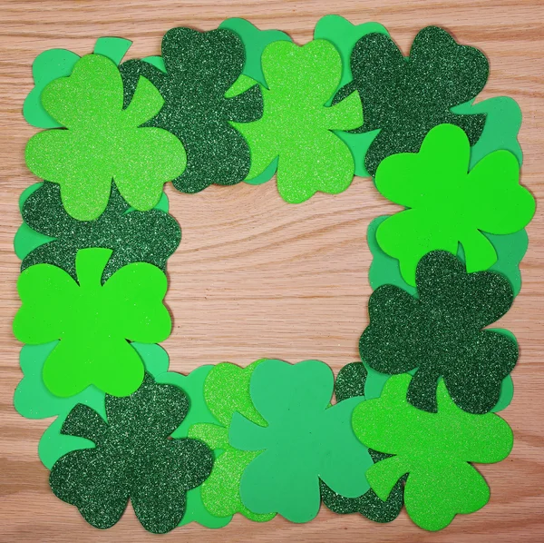 St. Patrick's Day. Shamrock Frame over wood background