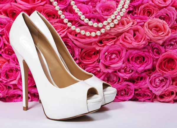 Bridal Shoes and Roses. White Heels over Hot Pink Flowers — Stock Photo, Image