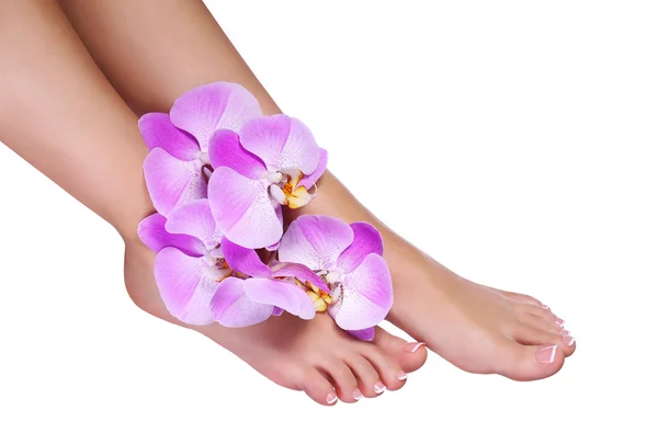 Pedicure with pink orchid flowers isolated on white — Stock Photo, Image