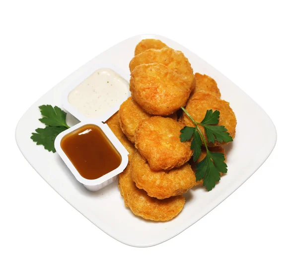 Nuggets de poulet en assiette avec deux pansements isolés sur blanc — Photo