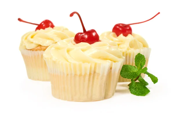 Cakes with butter cream , cherries and mint — Stock Photo, Image