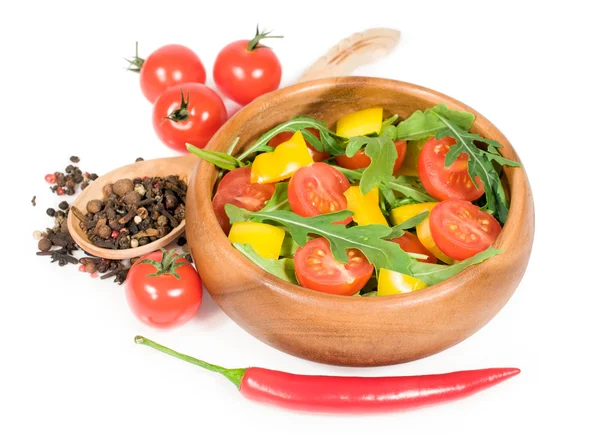 Salad with cherry tomatoes , sweet peppers and arugula in a wooden bowl — Stock Photo, Image