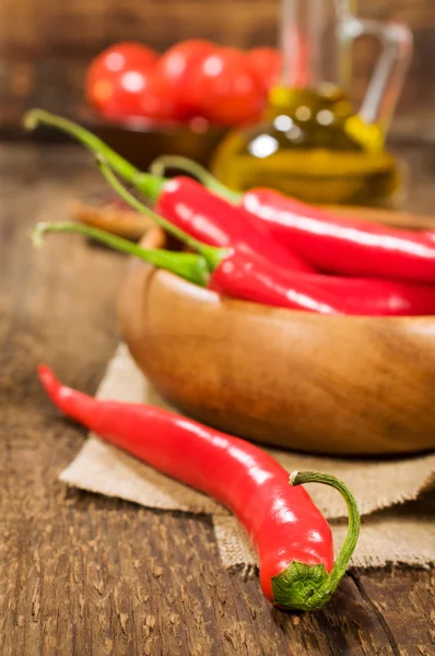 Still life with chili in wooden bowl — Stock Photo, Image