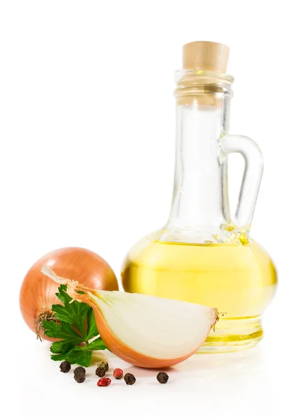 Sunflower oil in a glass bottle with onion and parsley — Stock Photo, Image