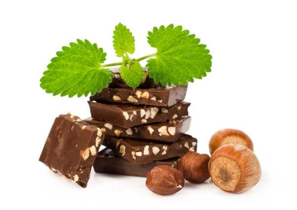 Chocolate with hazelnuts and fresh mint leaves — Stock Photo, Image