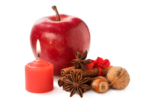 Apple with nuts, star anise , cinnamon and a candle — Stock Photo, Image