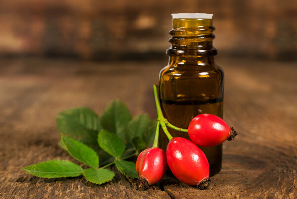 bottle of essential oil of rose hips