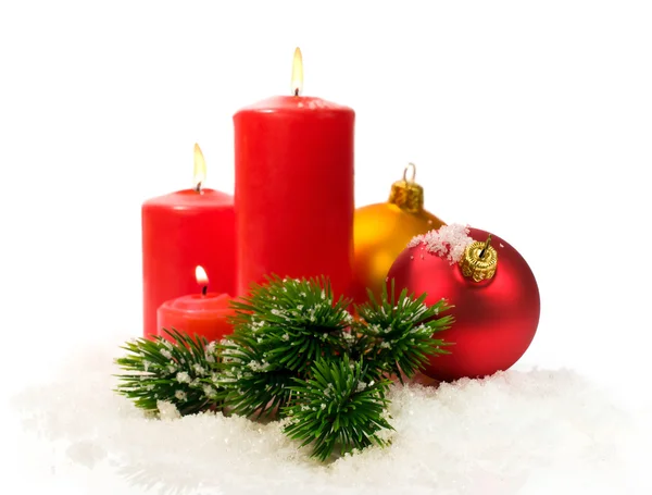 Candele rosse e rami di abete e palle di Natale nella neve — Foto Stock