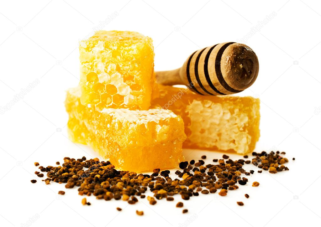 honey comb with a wooden dipper and pollen