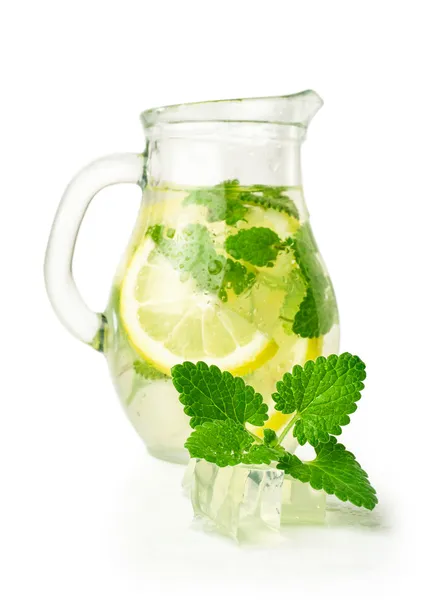 Lemonade with ice and mint in a glass jug — Stock Photo, Image