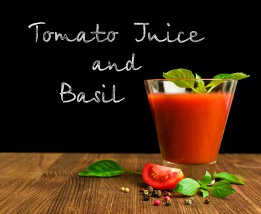 tomato juice with basil on blackboard 