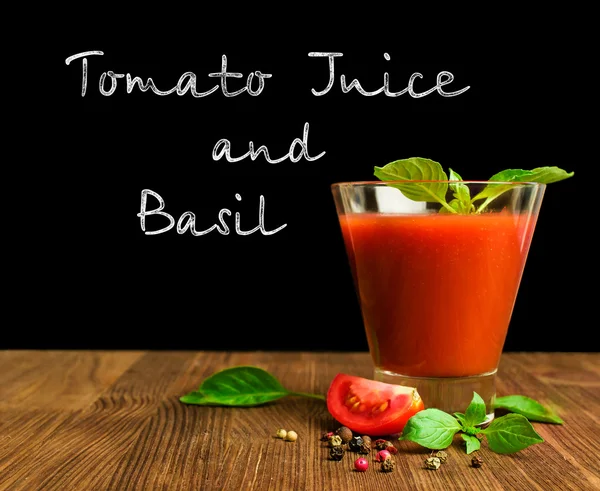 Tomato juice with basil on blackboard — Stock Photo, Image