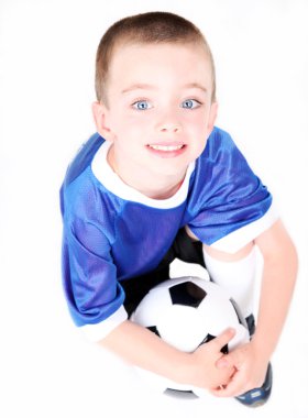 Young preschool boy with a soccer ball clipart