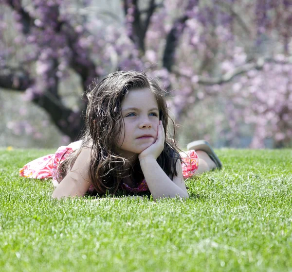 Menina deitada na grama — Fotografia de Stock