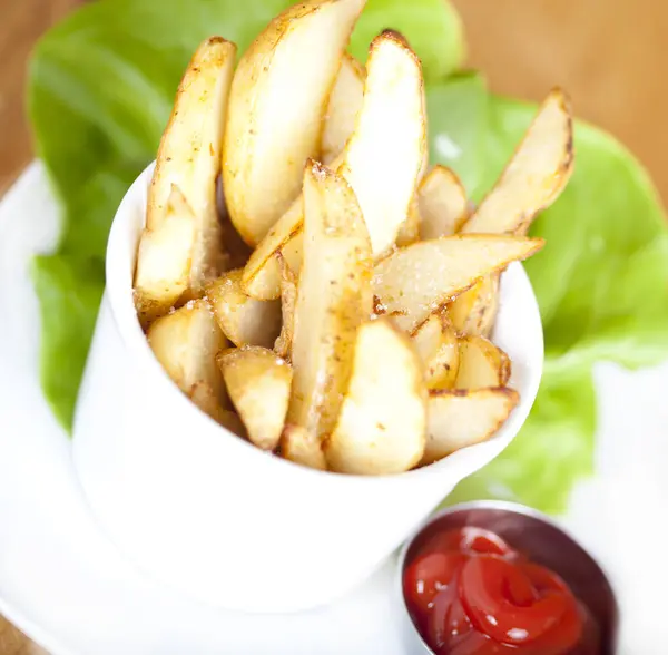 Potato Wedges on plate served with ketchup — Stock Photo, Image