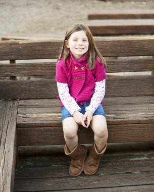 tatlı güzel bir kız parkta bir bankta oturan