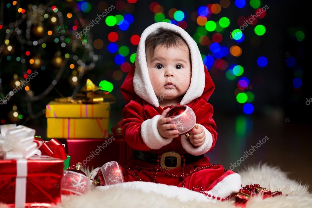 kid girl dressed as santa claus near christmas tree with gifts stock photo - Santa Claus For Toddlers kid girl dressed as santa claus near christmas tree with gifts stock photo - Santa Claus For Toddlers