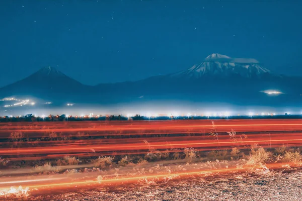 Mountain and night sky. car traffic and mount. Night landscape with a mountain and starry sky. Mount Ararat