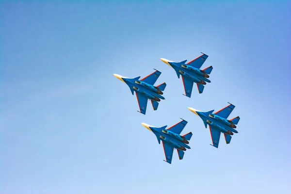 Four military planes in the sky are showing a show. Military fighters Su-30 SM. Bombers fly in the sky
