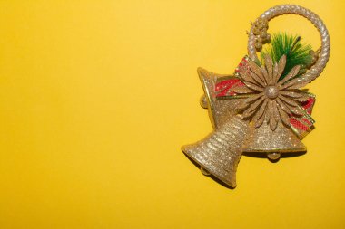 Bell on a yellow background. Christmas design with bell