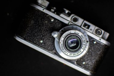 A camera with a metal body and a lens. Old cameras. Antiques