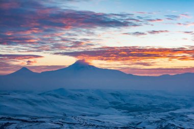 Mountain and sun. Sunrise on Mount Ararat. Fantastic landscape with mountain and sunrise. Silhouettes of mountains and orange sky